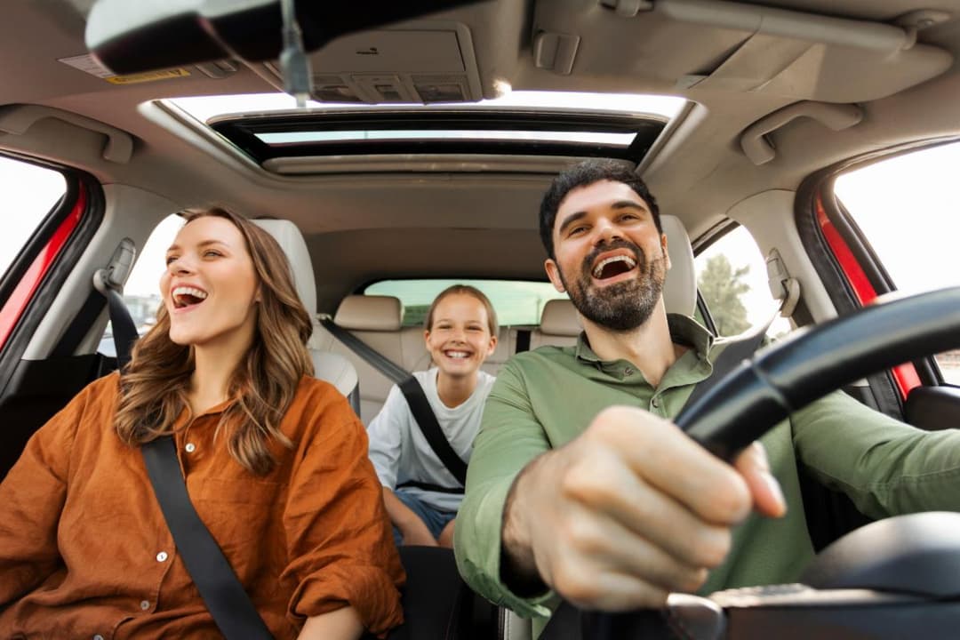 Happy family driving together with insurance protection